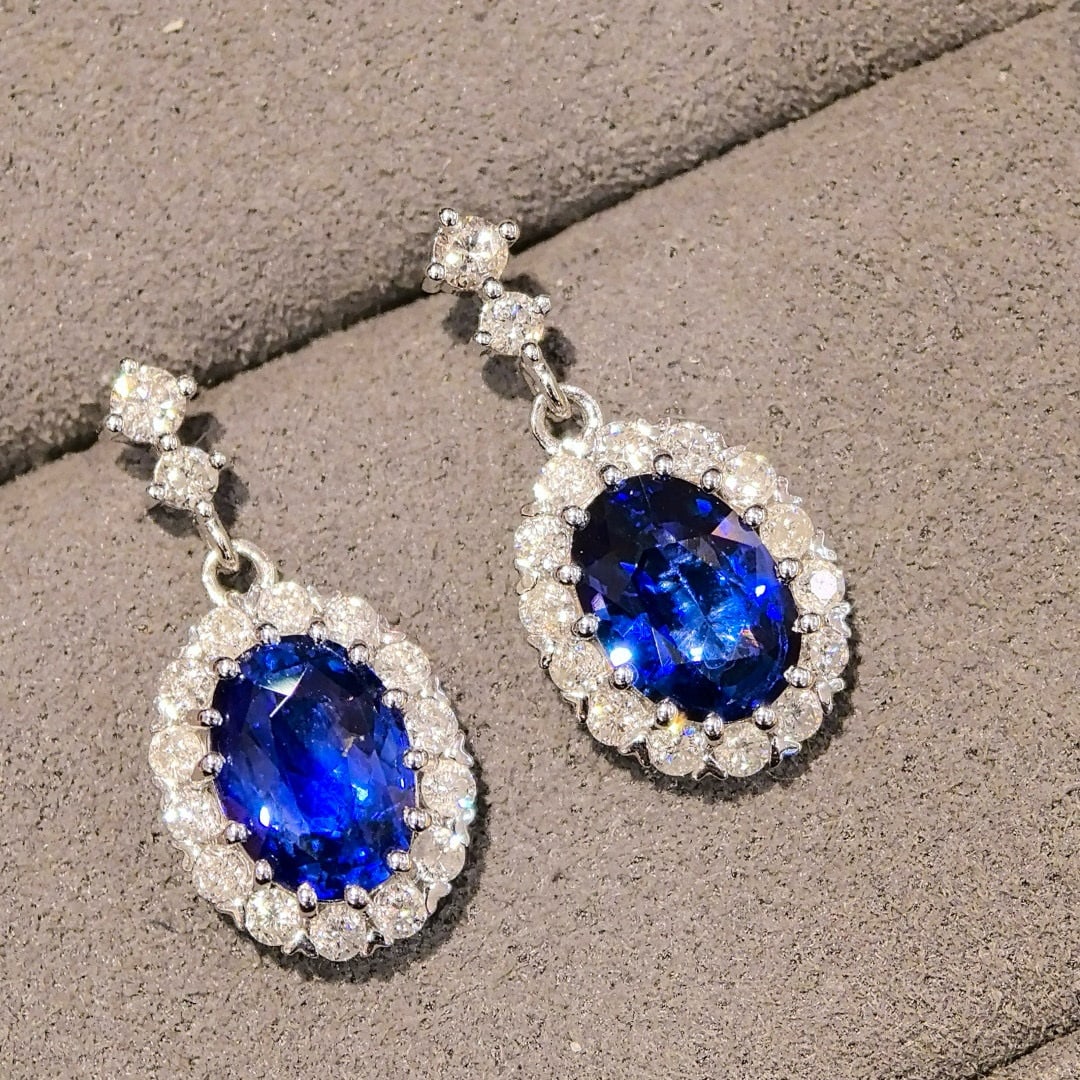 14k Gold 2.87 Ctw Natural Sapphire & Diamond Earrings: Ref:231060087 // gold content:14k gold // main gemstone:sapphire // shape:oval // carat weight:2. 27ct // color:royal blue // treatment:natural // // adjacent gemstone 2 : diamond // shape:round //