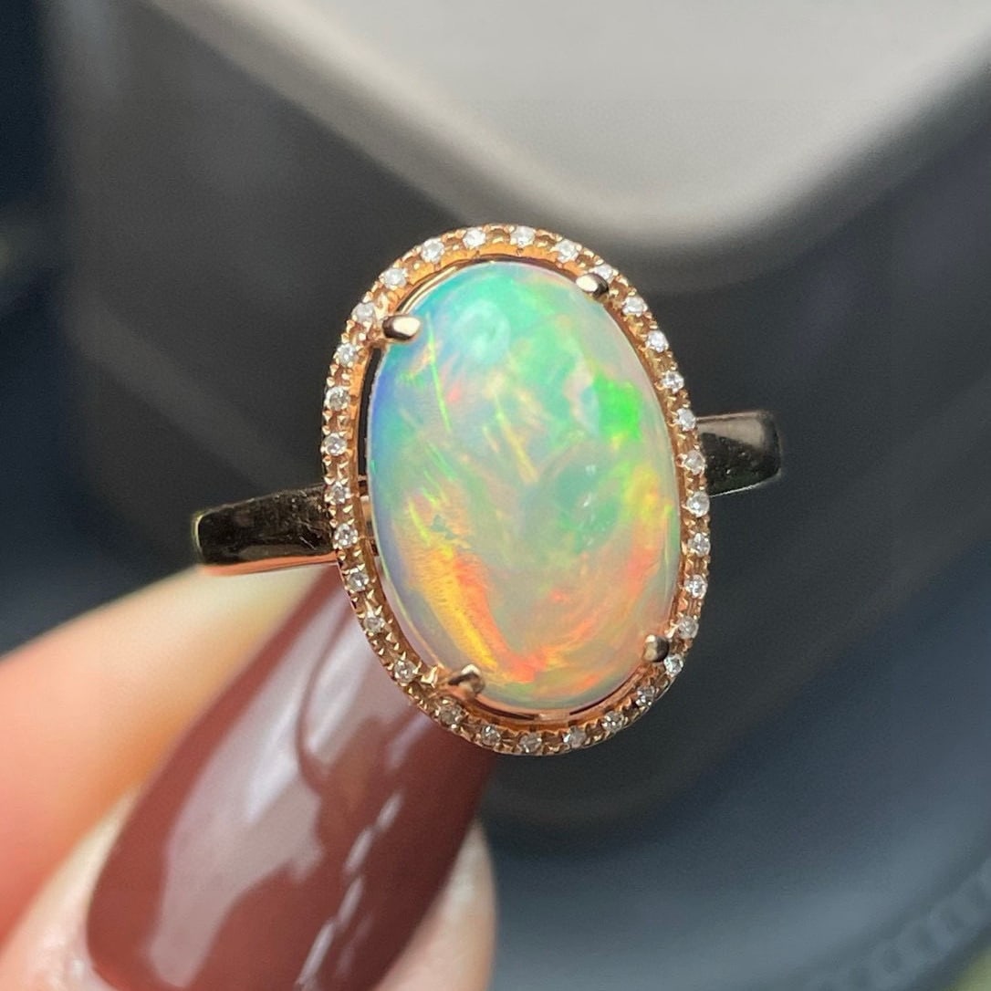 14k Gold 4.07 Ct Natural Opal & Diamond Ring: Ref:231062322 // gold content:14k gold // ring size:7. 25us // // main gemstone:opal // shape:oval // carat weight:4. 07ct // color:color // treatment:natural // // adjacent gemstone 2 : diamond
