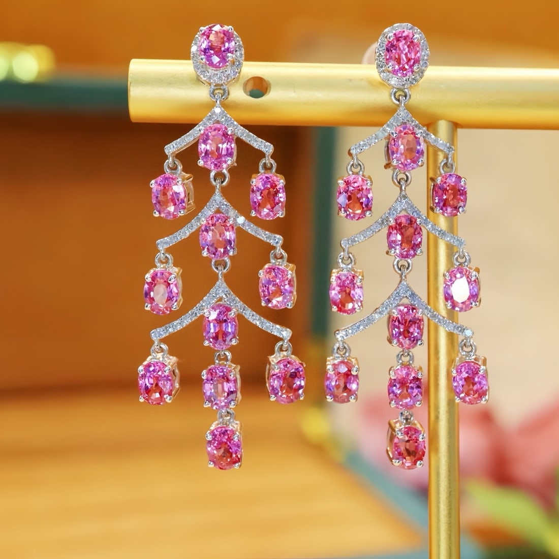 14k Gold 7.56 Ctw Natural Padparadscha Sapphire & Diamond Earrings: Ref:231124132 // gold content:14k gold // main gemstone:padparadscha sapphire // shape:oval // carat weight:7. 2ct // color:orangish pink // treatment:natural // // adjacent gemstone 2 : diamond //