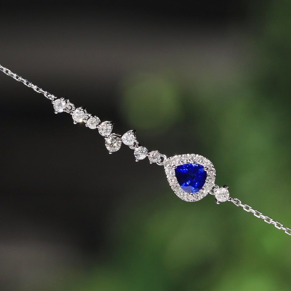 14k Gold 0.95 Ctw Vivid Blue Natural Sapphire & Diamond Bracelet: Ref:231124419 // gold content:14k gold // main gemstone:sapphire // shape:pear // carat weight:0. 45ct // color:vivid blue // treatment:natural // // adjacent gemstone 2 : diamond // shape:round //