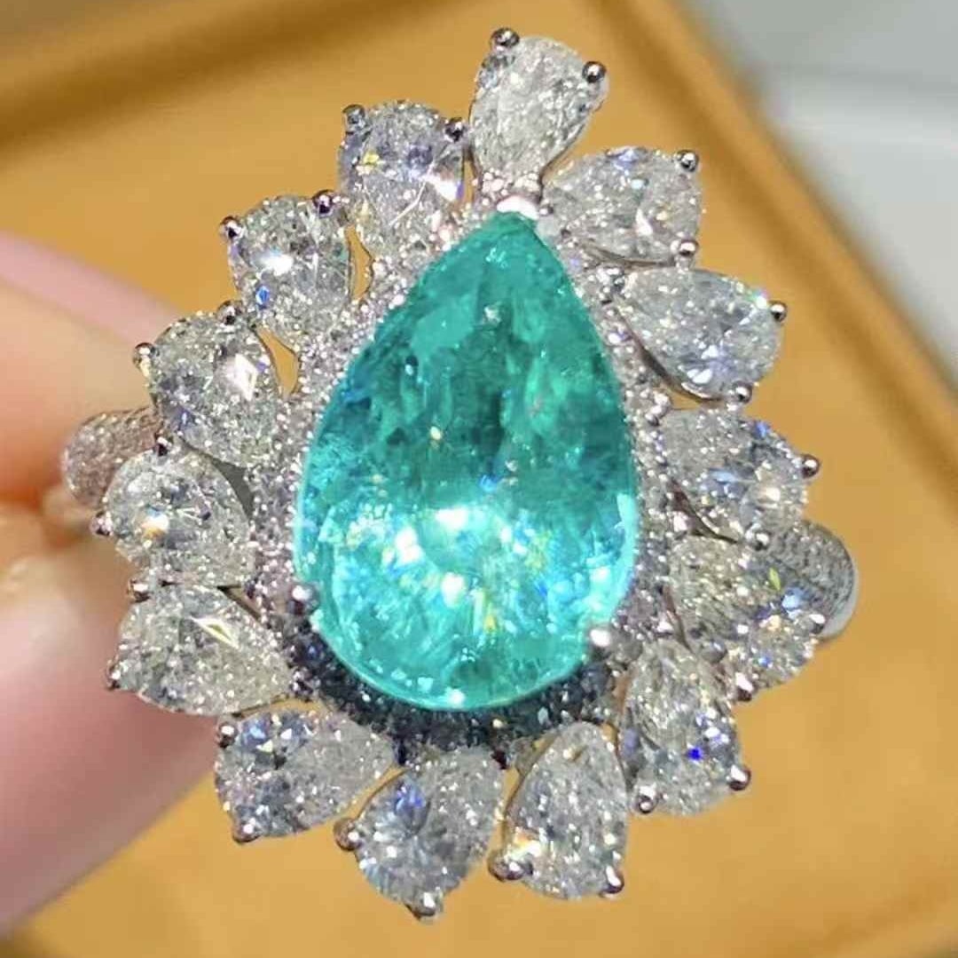 14k Gold 2.25 Ct Natural Paraiba Tourmaline & Diamond Ring: Ref:231067054 // gold content:14k gold // ring size:7. 25 us // // main gemstone:paraiba tourmaline // shape:pear // carat weight:2. 25ct // color:neon blue // treatment:natural // // adjacent