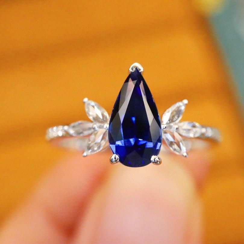 14k Gold 1.40 Ctw Natural Sapphire & Diamond Ring: Ref:231068118 // gold content:14k gold // ring size:7. 25us // // main gemstone:sapphire // shape:pear // carat weight:1. 26ct // color:royal blue // treatment:natural // // adjacent gemstone 2 :