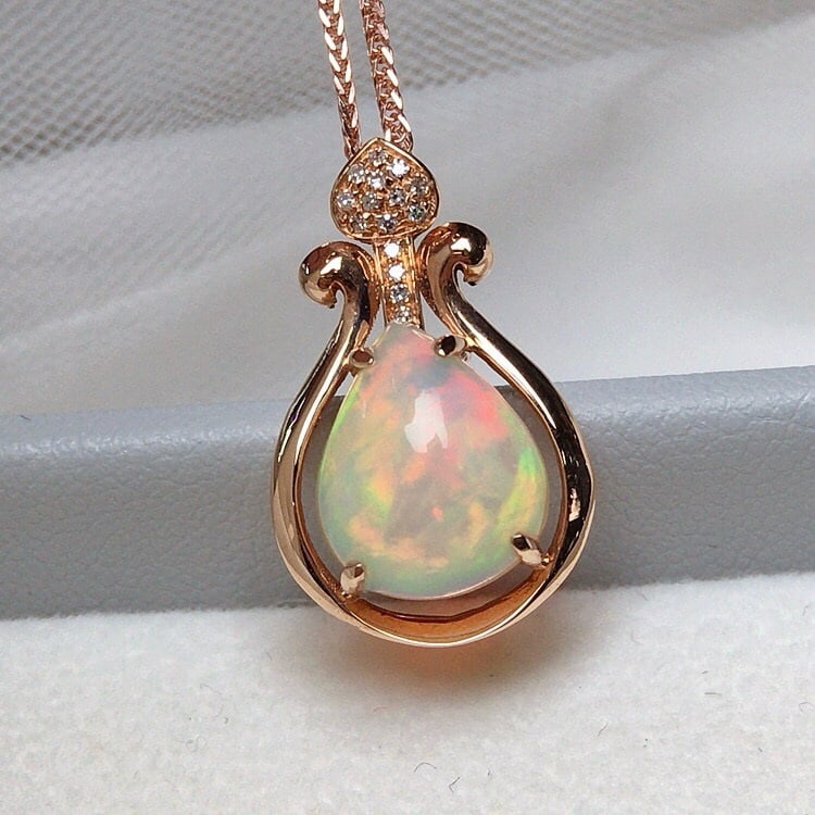 14k Gold 2.10 Ct Natural Opal & Diamond Pendant( Without Chain ): Ref:231068178 // gold content:14k gold // main gemstone:opal // shape:pear // carat weight:2. 10ct // color:color // treatment:natural // // adjacent gemstone 2 : diamond // number of stones:15 //