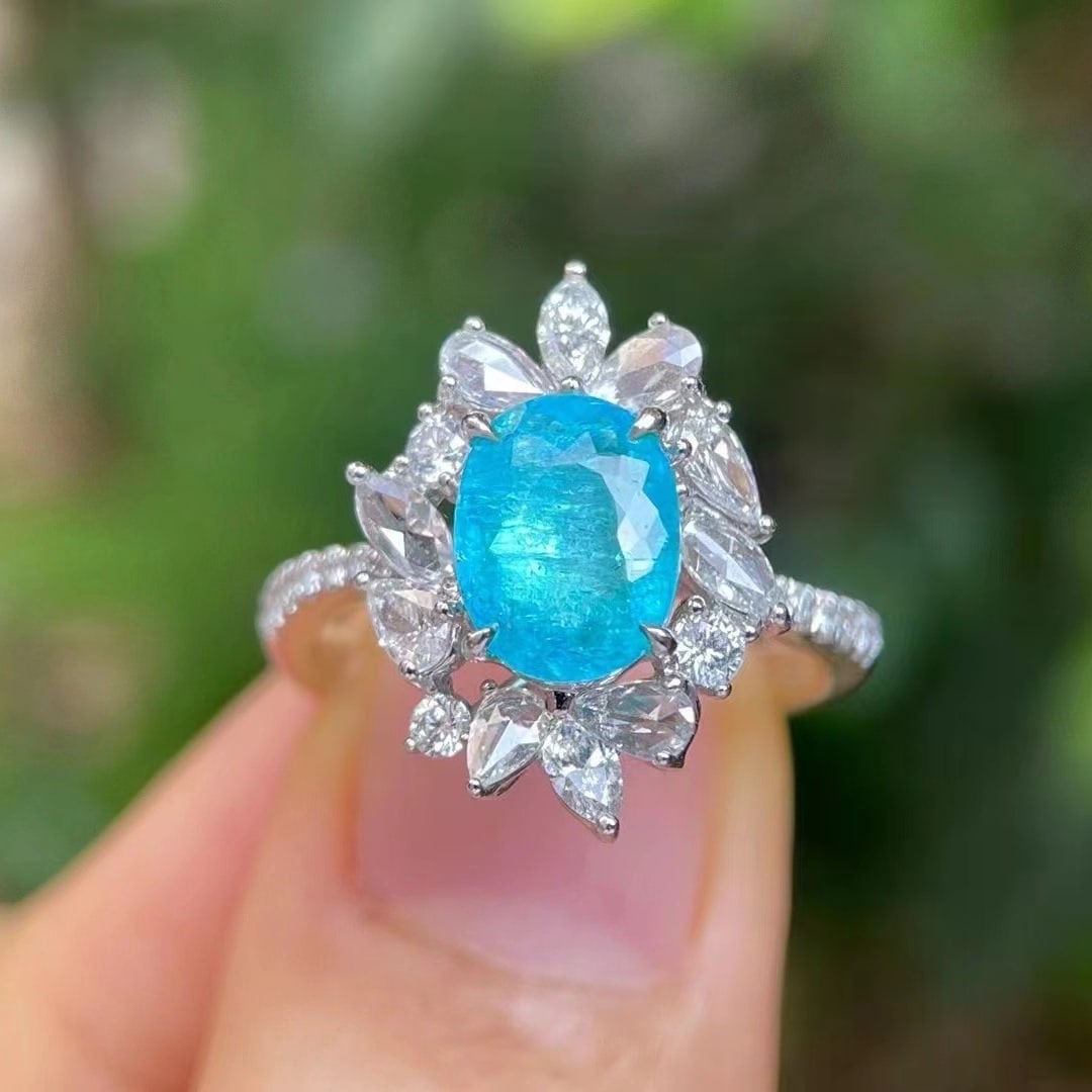 14k Gold 2.40 Ctw Natural Paraiba Tourmaline & Diamond Ring: Ref:230971009 // gold content:14k gold // ring size:7. 25us // // main gemstone:paraiba tourmaline // shape:oval // carat weight:1. 62ct // color:blue // treatment:natural // // adjacent gemstone 2 :