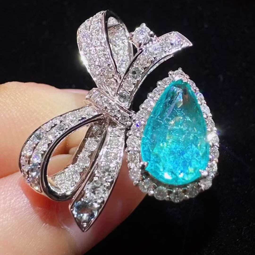 14k Gold 1.61 Ctw Natural Paraiba Tourmaline & Diamond Ring: Ref:231131102 // gold content:14k gold // ring size:7. 25us // // main gemstone:paraiba tourmaline // shape:pear // carat weight:0. 84ct // color:blue // treatment:natural // // adjacent gemstone 2 :