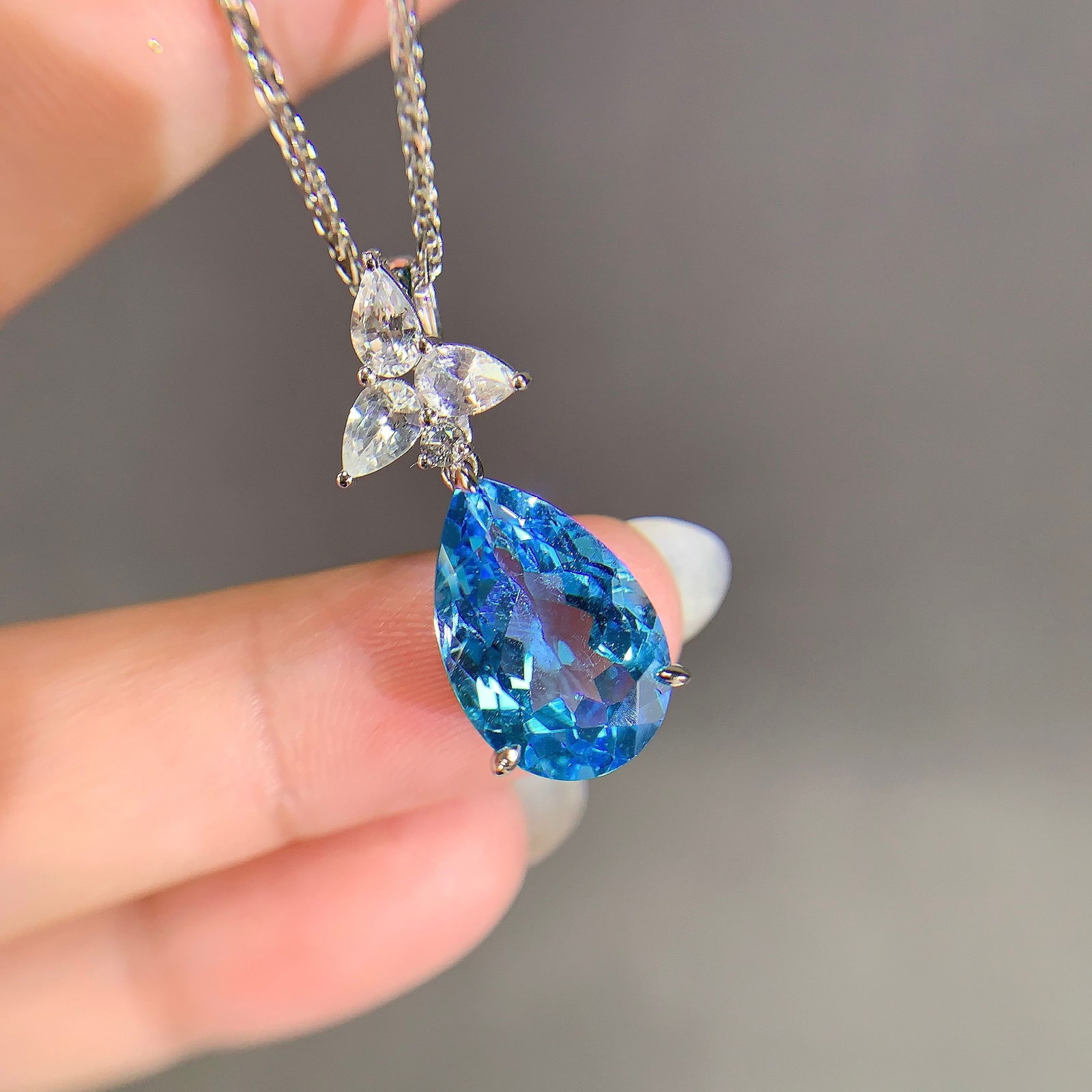 14k Gold 8.67 Ctw Natural Topaz & Sapphire Pendant( Without Chain ): Ref:231104177 // gold content:14k gold // main gemstone:topaz // shape:pear // carat weight:7. 76ct // color:blue // treatment:natural // // adjacent gemstone 2 : sapphire // shape:multiple //