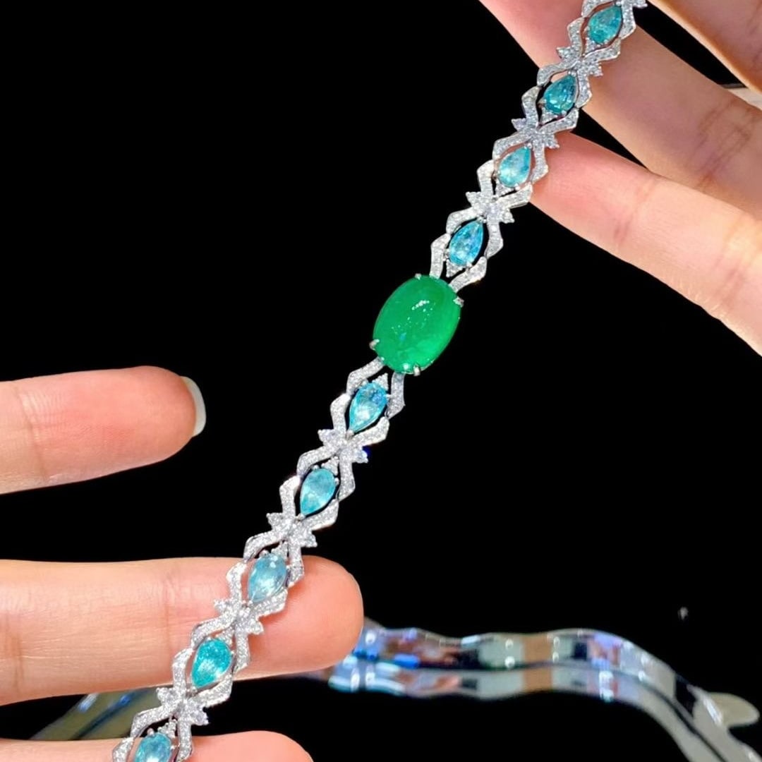 14k Gold 9.1 Ctw Natural Emerald & Paraiba Tourmaline Bracelet: Ref:231111137 // gold content:14k gold // main gemstone:emerald // shape:oval // carat weight:5. 6ct // color:green // treatment:natural // // adjacent gemstone 2 : paraiba tourmaline // shape:pear