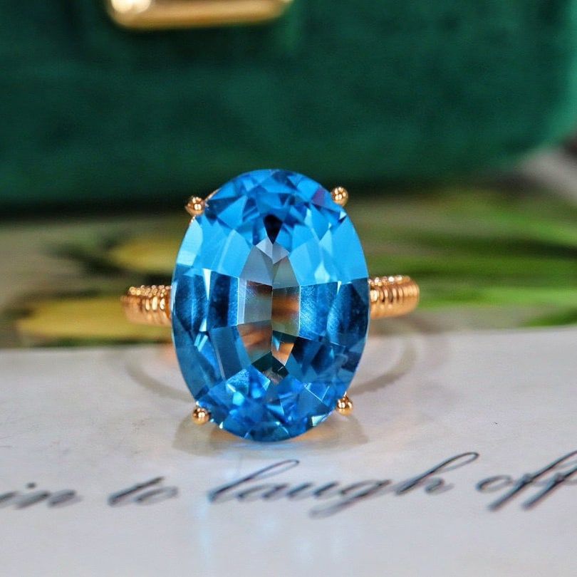 14k Gold 6.58 Ctw Natural Topaz & Diamond Ring: Ref:230936041 // gold content:14k gold // ring size:7. 25us // // main gemstone:topaz // shape:oval // carat weight:6. 55ct // color:blue // treatment:natural // // adjacent gemstone 2 : diamond // nu