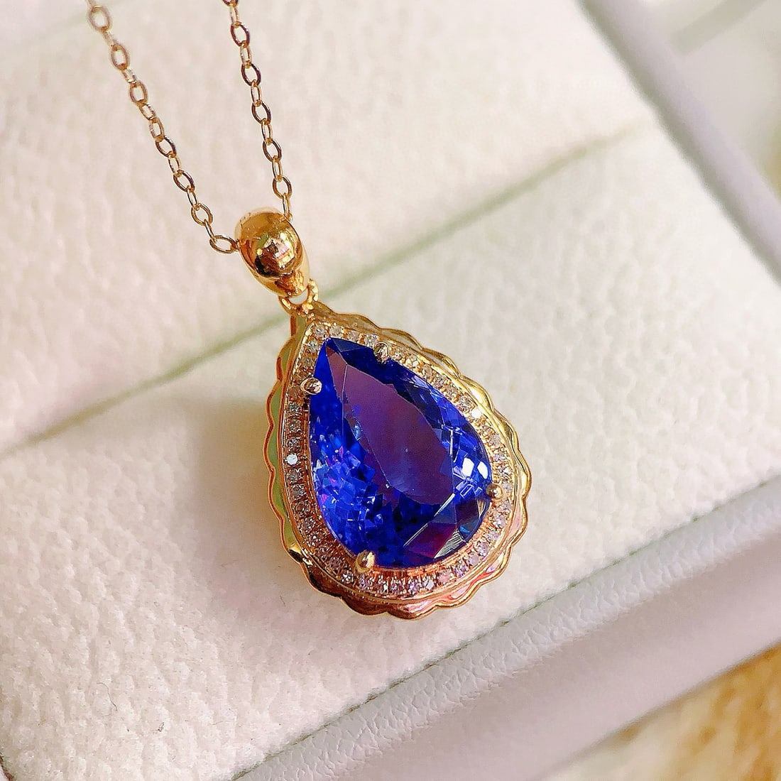 14k Gold 3.9 Ct Natural Tanzanite & Diamond Pendant( Without Chain ): Ref:230936301 // gold content:14k gold // main gemstone:tanzanite // shape:pear // carat weight:3. 9ct // color:blue // treatment:natural // // adjacent gemstone 2 : diamond // number of stones:45