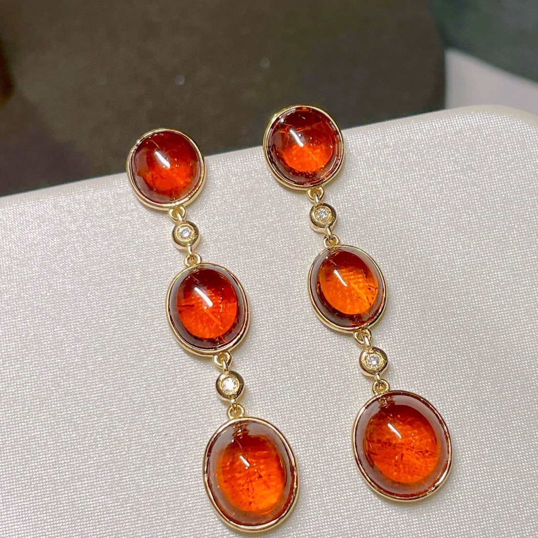 14k Gold 20.5 Ct Natural Spessartine Earrings: Ref:230941232 // gold content:14k gold // main gemstone:spessartine // shape:oval // carat weight:20. 5ct // color:orange // treatment:natural // Condition: NewLow Estimate: 7300High Estimate: 11000