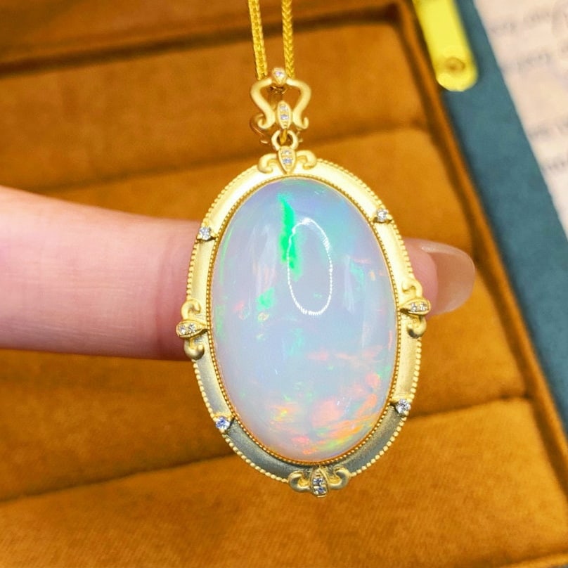 14k Gold 21.12 Ctw Natural Opal & Diamond Pendant( Without Chain ): Ref:230942010 // gold content:14k gold // main gemstone:opal // shape:oval // carat weight:21. 05ct // color:white // treatment:natural // // adjacent gemstone 2 : diamond // number of stones:16 //
