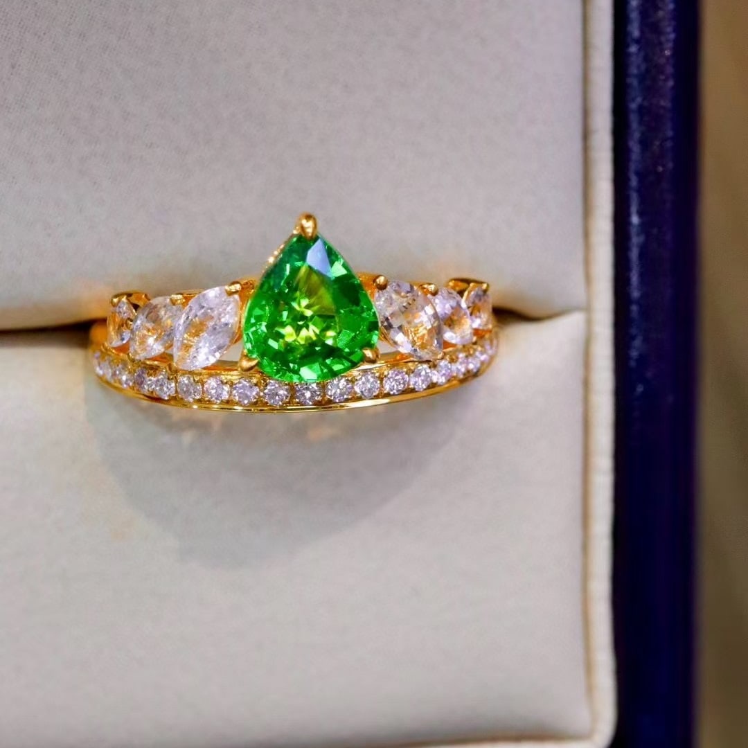 14k Gold 1.48 Ctw Natural Tsavorite & Sapphire Ring: Ref:230944321 // gold content:14k gold // ring size:7. 25us // // main gemstone:tsavorite // shape:pear // carat weight:0. 85ct // color:green // treatment:natural // // adjacent gemstone 2 : sapphire