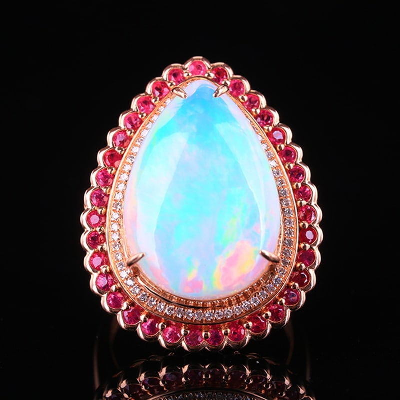 14k Gold 11.58 Ctw Natural Opal & Ruby Ring: Ref:230951017 // gold content:14k gold // ring size:7. 25us // // main gemstone:opal // shape:pear // carat weight:10. 43ct // color:white // treatment:natural // // adjacent gemstone 2 : ruby // numb