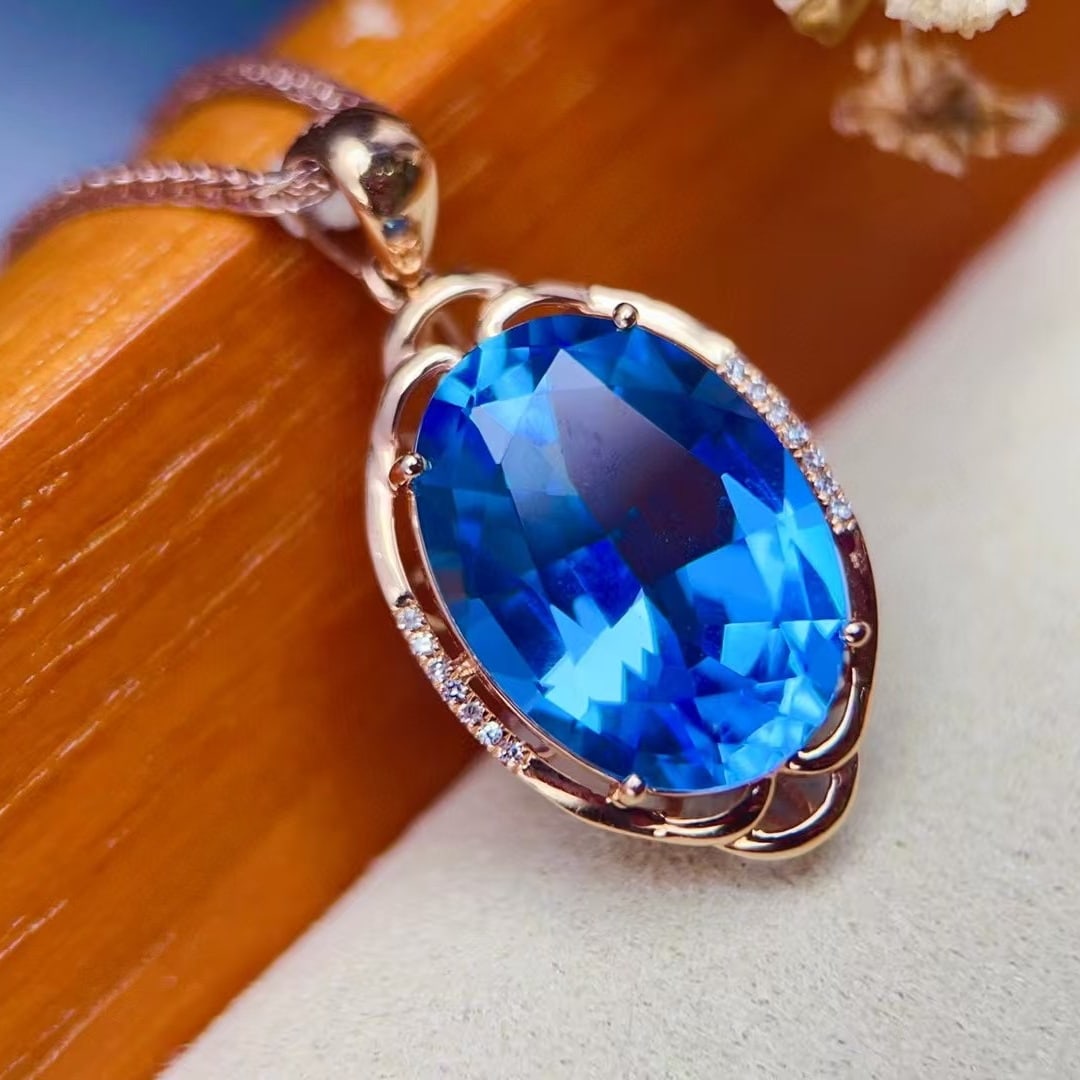 14k Gold 10.19 Ctw Natural Topaz & Diamond Pendant( Without Chain ): Ref:230964434 // gold content:14k gold // main gemstone:topaz // shape:oval // carat weight:10. 15ct // color:blue // treatment:natural // // adjacent gemstone 2 : diamond // number of stones:14 //