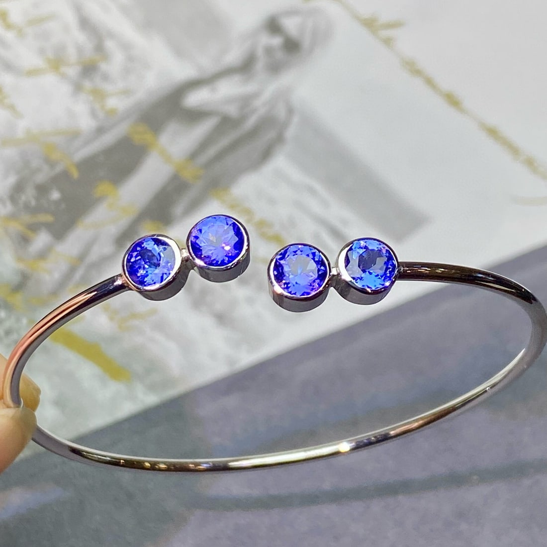 14k Gold 2.8 Ct Natural Tanzanite Bangle: Ref:230983062 // gold content:14k gold // main gemstone:tanzanite // shape:round // carat weight:2. 8ct // color:blue // treatment:natural // cut grade:g // Low Estimate: 3700 Condition: New High