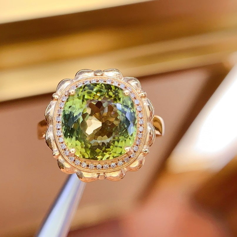 14k Gold 6.8 Ct Natural Tourmaline & Diamond Ring: Ref:230983167 // gold content:14k gold // ring size:7. 25us // // main gemstone:tourmaline // shape:oval // carat weight:6. 8ct // color:yellowish green // treatment:natural // // adjacent gemstone 2