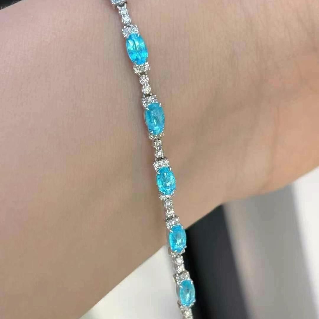 14k Gold 1.5 Ct Natural Paraiba Tourmaline & Diamond Bracelet: Ref:230986254 // gold content:14k gold // main gemstone:paraiba tourmaline // shape:oval // carat weight:1. 5ct // color:blue // treatment:natural // // adjacent gemstone 2 : diamond // shape:round