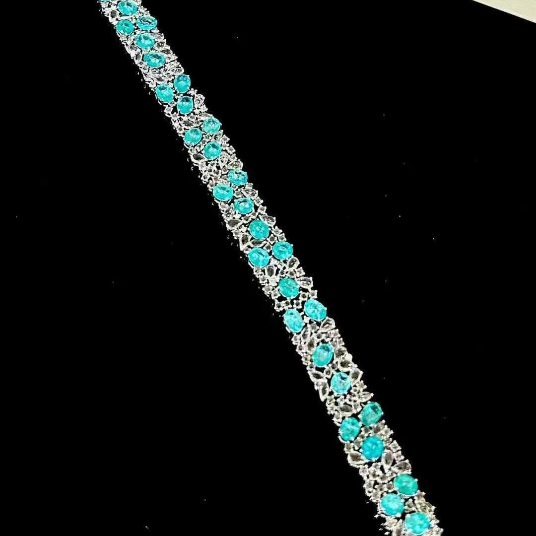 14k Gold 12.6 Ct Natural Paraiba Tourmaline & Sapphire Bracelet: Ref:230986369 // gold content:14k gold // main gemstone:paraiba tourmaline // shape:oval // carat weight:12. 6ct // color:blue // treatment:natural // // adjacent gemstone 2 : sapphire //