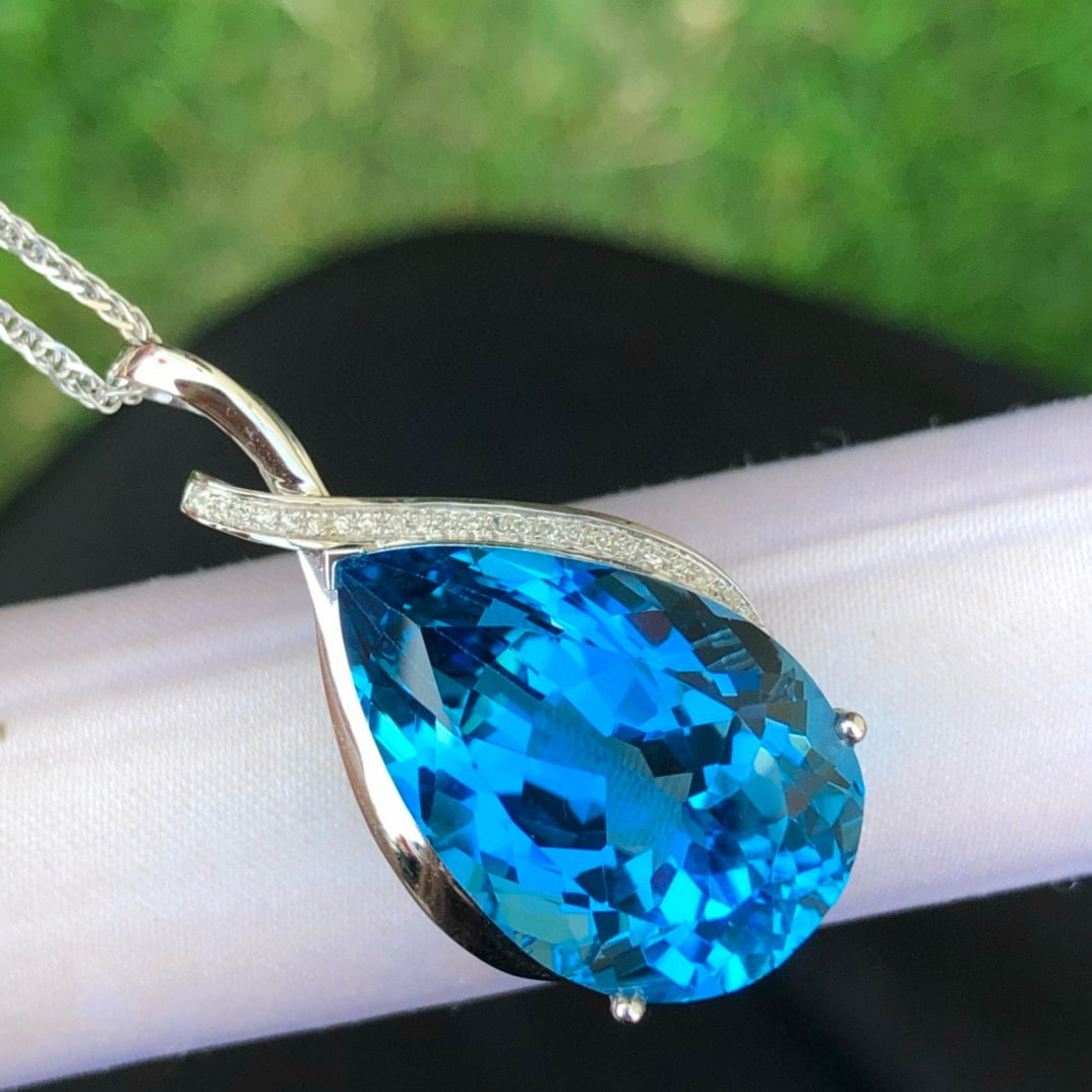 14k Gold 24 Ct Natural Topaz & Diamond Pendant( Without Chain ): Ref:230987056 // gold content:14k gold // main gemstone:topaz // shape:pear // carat weight:24ct // color:blue // treatment:natural // cut grade:g // // adjacent gemstone 2 : diamond // shape:round