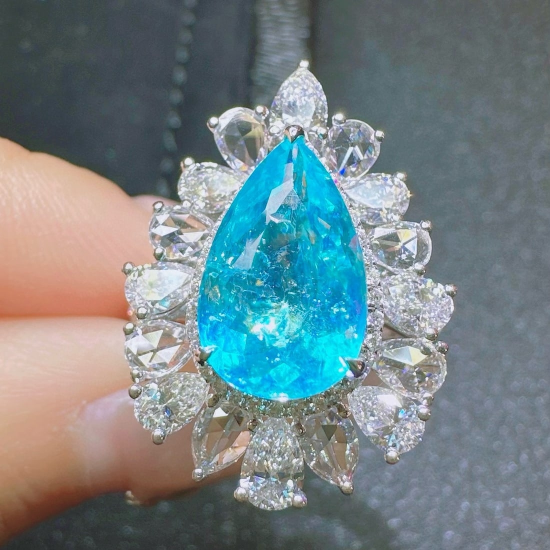 14k Gold 4.82 Ctw Natural Paraiba Tourmaline & Diamond Ring: Ref:230988350 // gold content:14k gold // ring size:7. 25us // // main gemstone:paraiba tourmaline // shape:pear // carat weight:2. 83ct // color:neon blue // treatment:natural // // adjacent gemstone