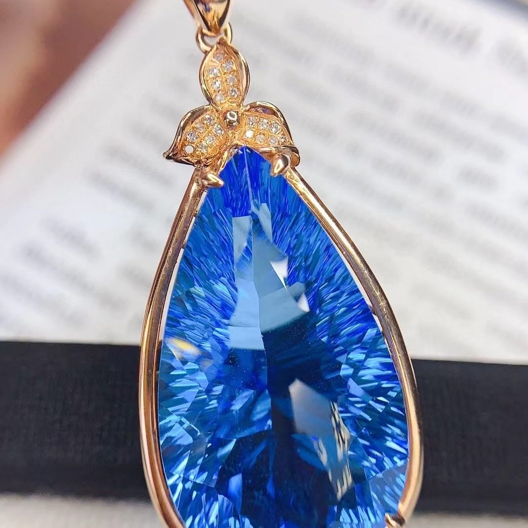 14k Gold 29 Ct Natural Topaz & Diamond Pendant( Without Chain ): Ref:230992143 // gold content:14k gold // main gemstone:topaz // shape:pear // carat weight:29ct // color:blue // treatment:natural // // adjacent gemstone 2 : diamond // number of stones:21 // shape: