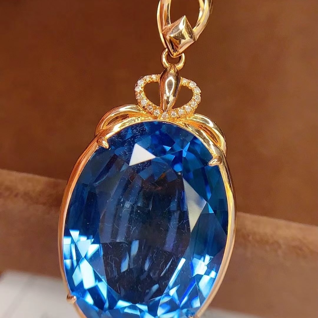 14k Gold 27 Ct Natural Topaz & Diamond Pendant( Without Chain ): Ref:230992144 // gold content:14k gold // main gemstone:topaz // shape:oval // carat weight:27ct // color:blue // treatment:natural // // adjacent gemstone 2 : diamond // number of stones:17 // shape: