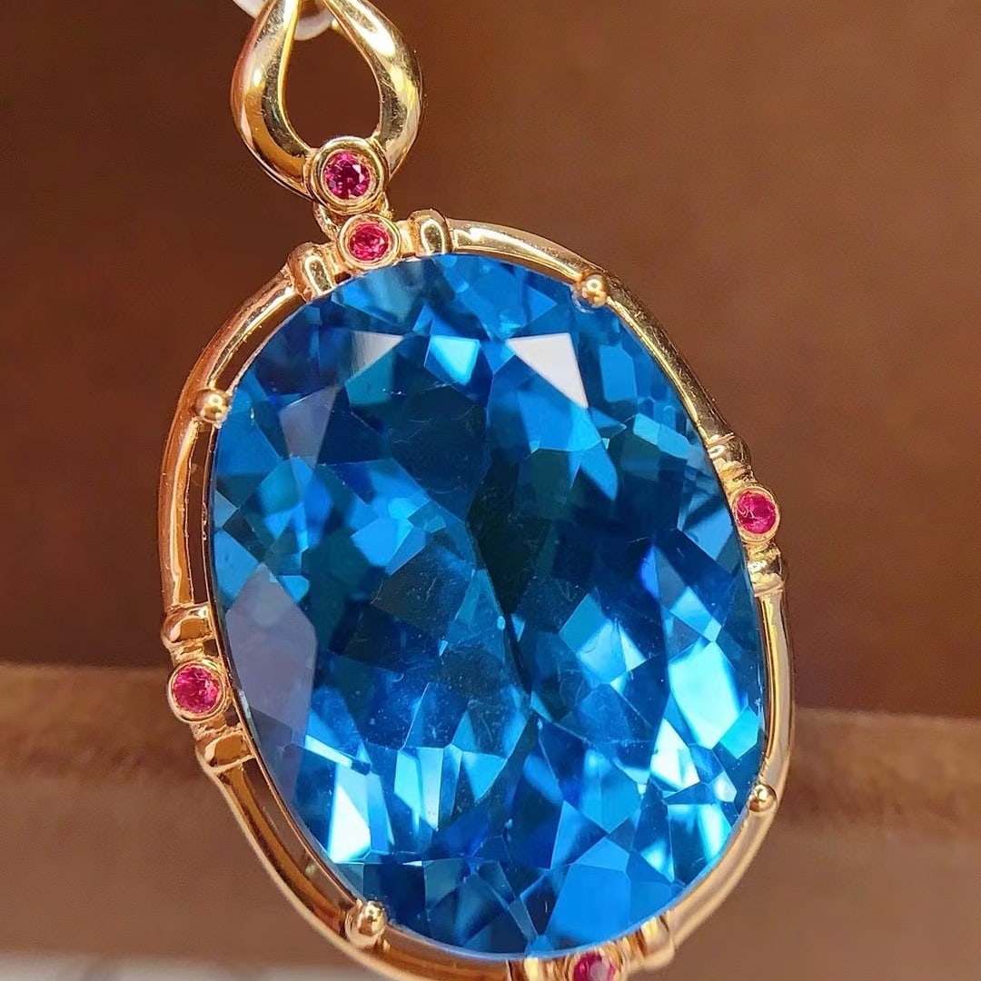 14k Gold 19.1 Ct Natural Topaz & Ruby Pendant( Without Chain ): Ref:230992248 // gold content:14k gold // main gemstone:topaz // shape:oval // carat weight:19. 1ct // color:blue // treatment:natural // // adjacent gemstone 2 : ruby // number of stones:5 // shape:r