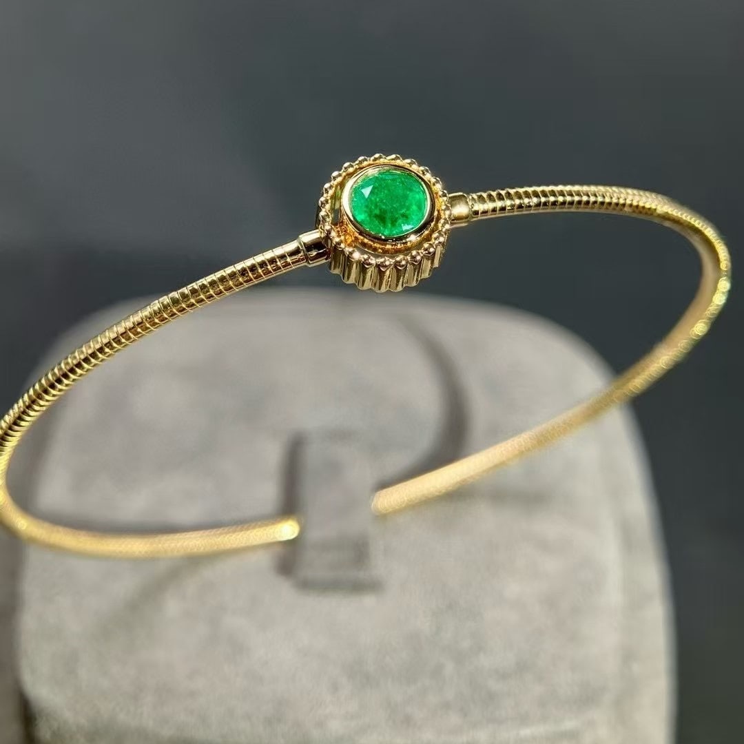 14k Gold 0.46 Ct Vivid Green Natural Emerald Bangle: Ref:230992292 // gold content:14k gold // main gemstone:emerald // shape:round // carat weight:0. 46ct // color:vivid green // treatment:natural // cut grade:g // Condition: New Low Estimate: 9500.00