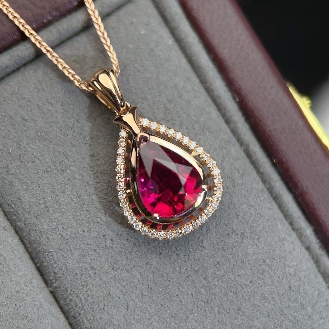 14k Gold 1.5 Ct Natural Tourmaline & Diamond Pendant( Without Chain ): Ref:230992300 // gold content:14k gold // main gemstone:tourmaline // shape:pear // carat weight:1. 5ct // color:red // treatment:natural // // adjacent gemstone 2 : diamond // number of stones:36 //