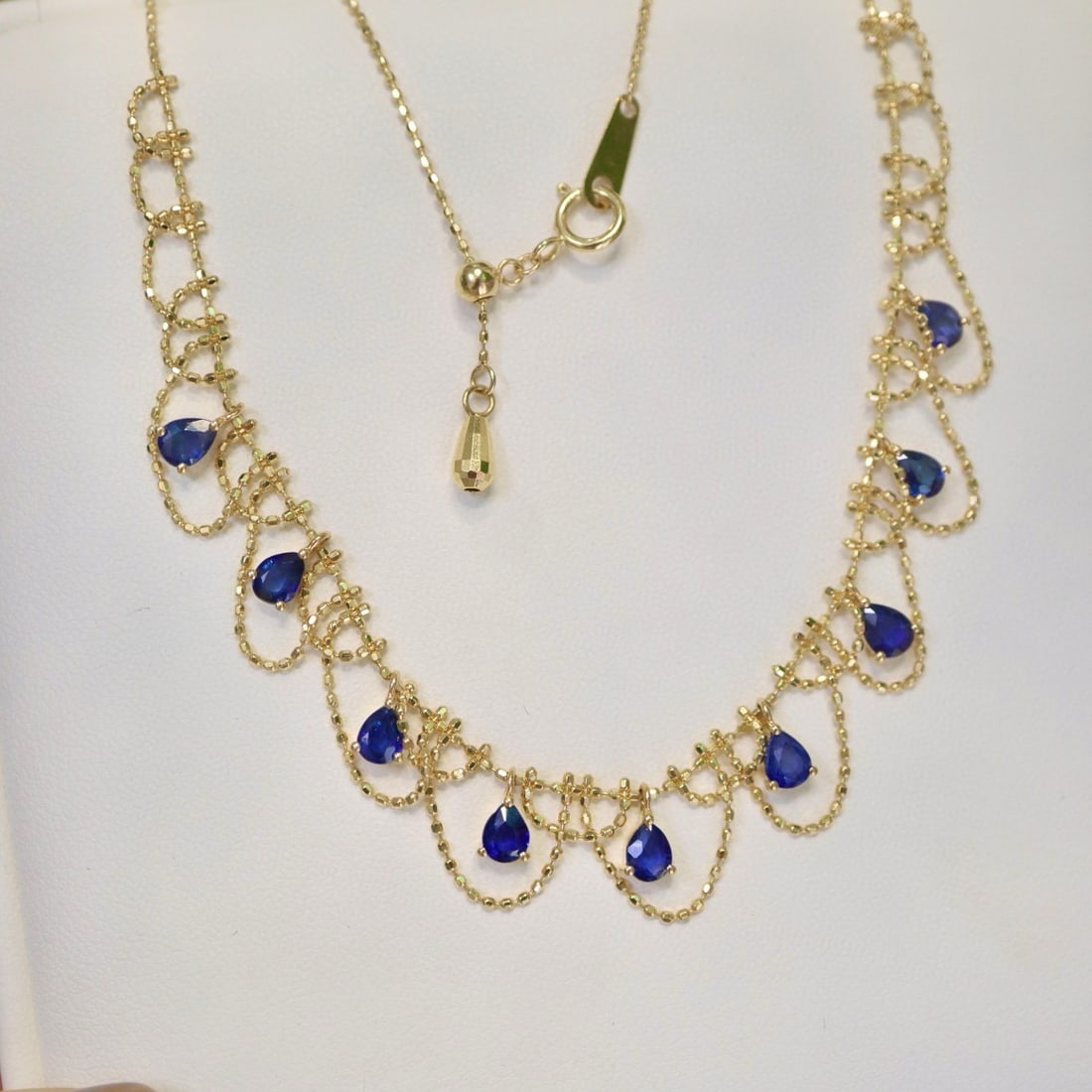 14k Gold 2.7 Ct Natural Sapphire Necklace: Ref:230994221 // gold content:14k gold // main gemstone:sapphire // shape:pear // carat weight:2. 7ct // color:blue // treatment:natural // Condition: New Low Estimate: 3100 High Estimate: 4600