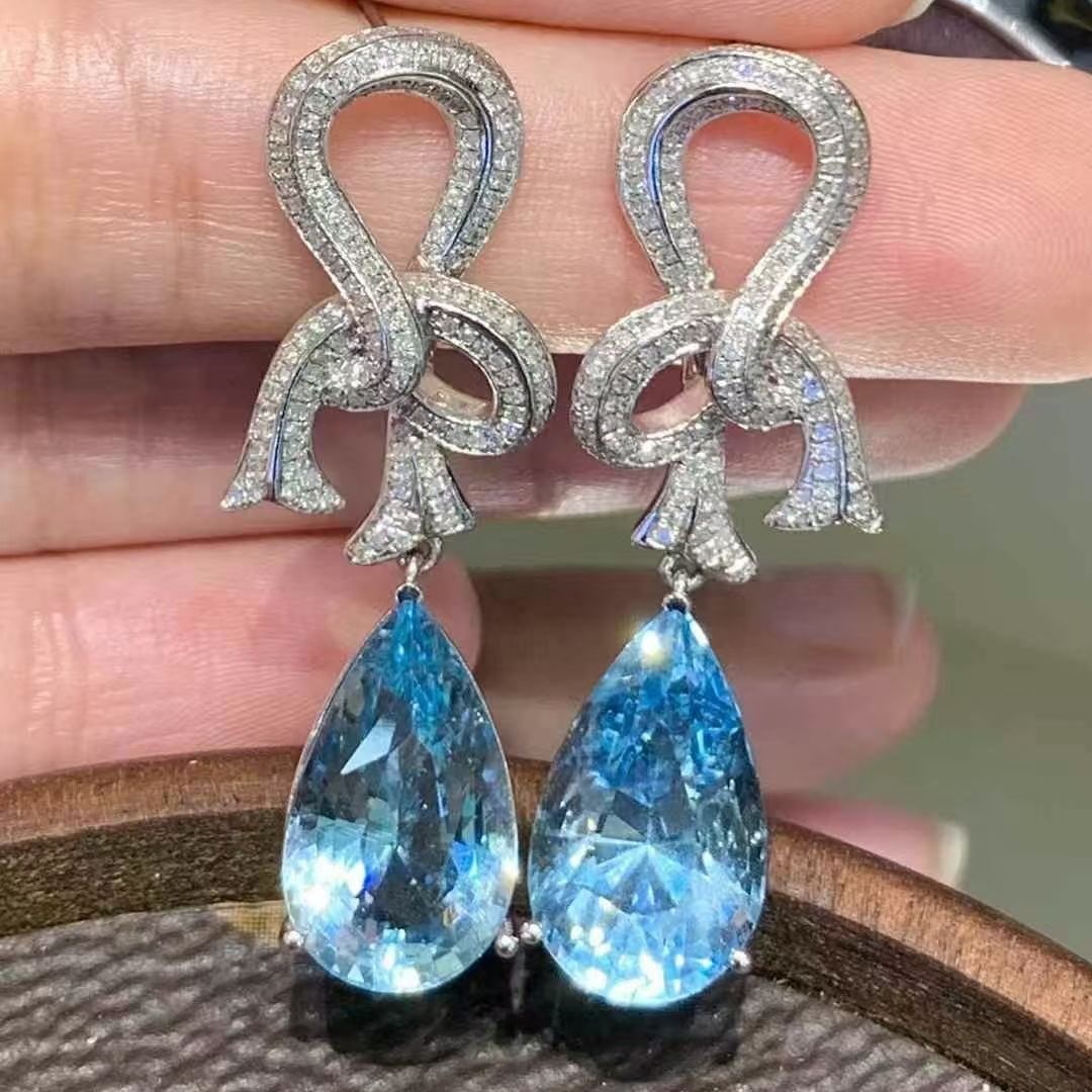 14k Gold 11.65 Ct Natural Aquamarine & Diamond Earrings: Ref:230995217 // gold content:14k gold // main gemstone:aquamarine // shape:pear // carat weight:11. 65ct // color:blue // treatment:natural // // adjacent gemstone 2 : diamond // shape:round //