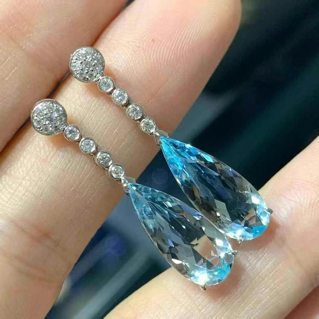 14k Gold 4.79 Ctw Natural Aquamarine & Diamond Earrings: Ref:230997049 // gold content:14k gold // main gemstone:aquamarine // shape:pear // carat weight:4. 57ct // color:blue // treatment:natural // // adjacent gemstone 2 : diamond // shape:round // carat 