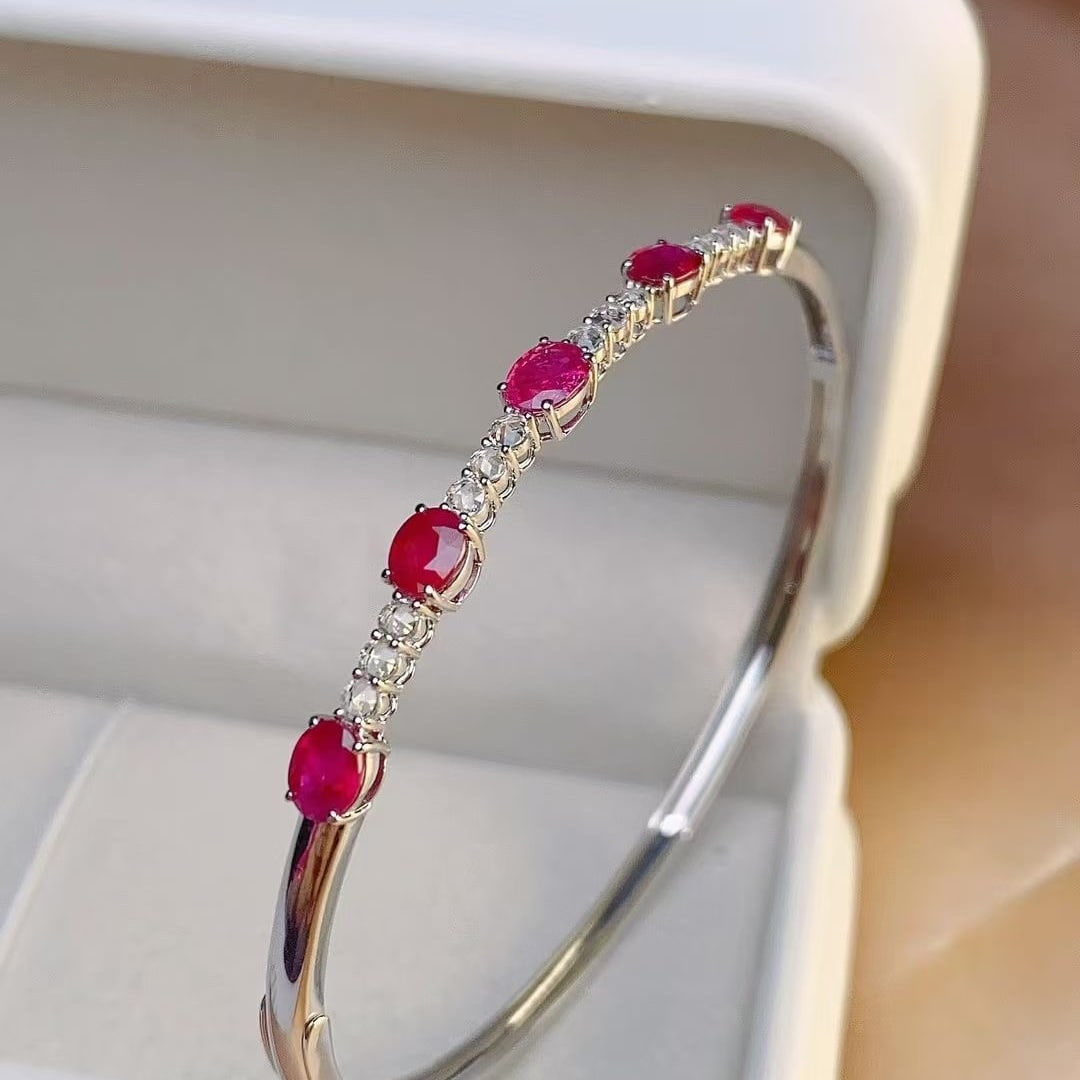 14k Gold 2 Ct Natural Ruby & Diamond Bangle: Ref:230997121 // gold content:14k gold // main gemstone:ruby // shape:oval // carat weight:2ct // color:pigeonblood red // treatment:natural // // adjacent gemstone 2 : diamond // number of stones:12