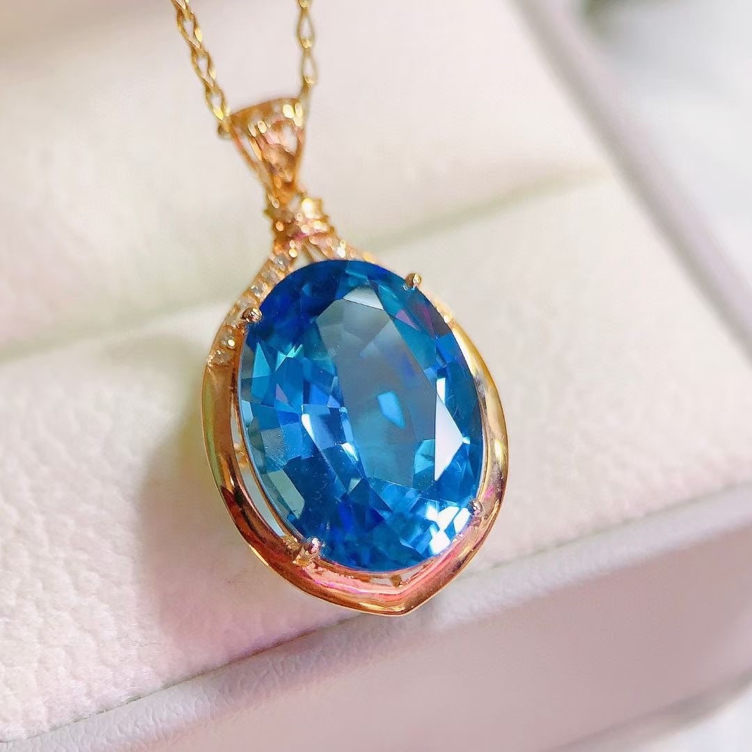 14k Gold 10.5 Ct Natural Topaz & Diamond Pendant( Without Chain ): Ref:230997131 // gold content:14k gold // main gemstone:topaz // shape:oval // carat weight:10. 5ct // color:blue // treatment:natural // // adjacent gemstone 2 : diamond // number of stones:14 //