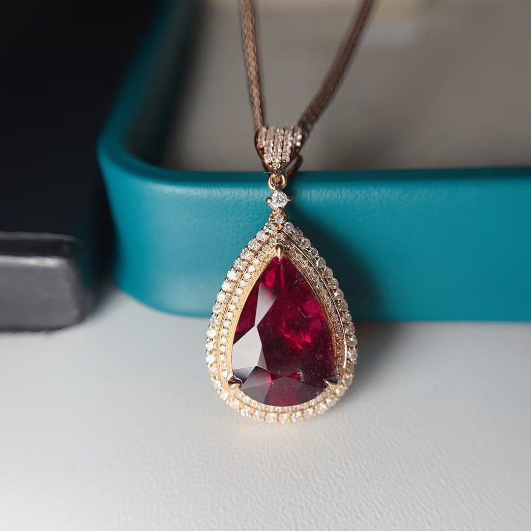 14k Gold 4.85 Ct Natural Tourmaline & Diamond Pendant( Without Chain ): Ref:231000115 // gold content:14k gold // main gemstone:tourmaline // shape:pear // carat weight:4. 85ct // color:red // treatment:natural // // adjacent gemstone 2 : diamond // number of stones:120 /