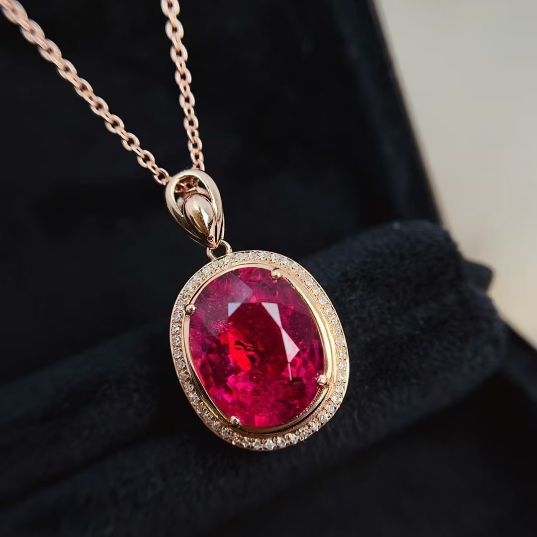 14k Gold 5.40 Ct Natural Tourmaline & Diamond Pendant( Without Chain ): Ref:231000142 // gold content:14k gold // main gemstone:tourmaline // shape:oval // carat weight:5. 40ct // color:red // treatment:natural // // adjacent gemstone 2 : diamond // number of stones:48 //