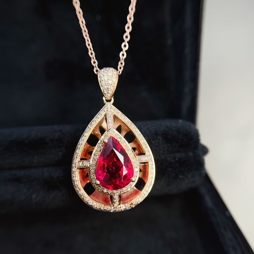 14k Gold 2.30 Ct Natural Tourmaline & Diamond Pendant( Without Chain ): Ref:231000143 // gold content:14k gold // main gemstone:tourmaline // shape:pear // carat weight:2. 30ct // color:red // treatment:natural // // adjacent gemstone 2 : diamond // number of stones:134