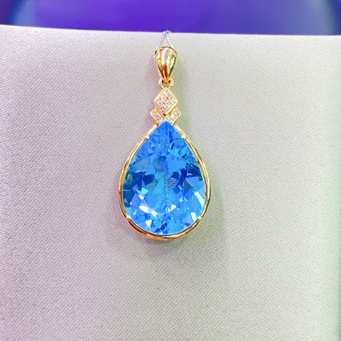 14k Gold 12.79 Ctw Natural Topaz & Diamond Pendant( Without Chain ): Ref:231001141 // gold content:14k gold // main gemstone:topaz // shape:pear // carat weight:12. 75ct // color:blue // treatment:natural // // adjacent gemstone 2 : diamond // number of stones:15 //