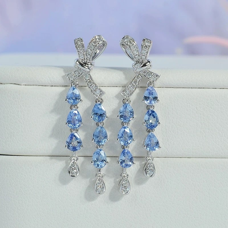 14k Gold 2.51 Ctw Natural Sapphire & Diamond Earrings: Ref:231007020 // gold content:14k gold // main gemstone:sapphire // shape:pear // carat weight:2. 28ct // color:blue // treatment:natural // // adjacent gemstone 2 : diamond // shape:round // carat