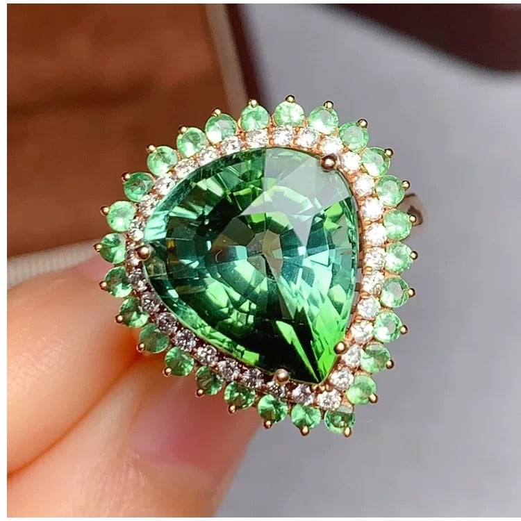 14k Gold 9 Ct Natural Tourmaline & Diamond Ring: Ref:231007033 // gold content:14k gold // ring size:7. 25us // // main gemstone:tourmaline // shape:pear // carat weight:9ct // color:green // treatment:natural // // adjacent gemstone 2 : diamond // 