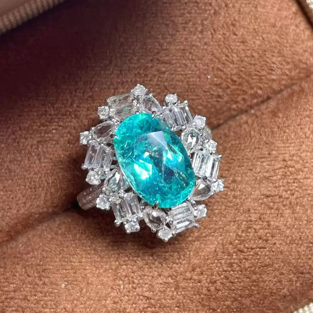 14k Gold 4.50 Ctw Natural Paraiba Tourmaline & Sapphire Ring: Ref:231007105 // gold content:14k gold // ring size:7. 25us // // main gemstone:paraiba tourmaline // shape:oval // carat weight:3. 44ct // color:neon blue // treatment:natural // // adjacent