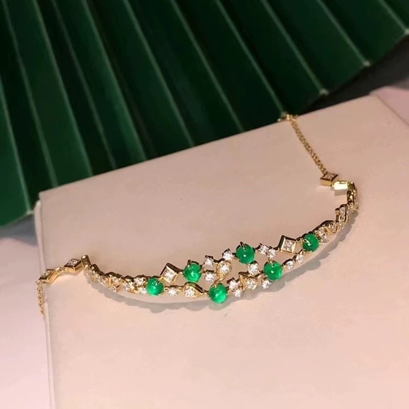 14k Gold 1.89 Ctw Natural Emerald & Diamond Bracelet: Ref:231007135 // gold content:14k gold // main gemstone:emerald // shape:round // carat weight:1. 06ct // color:green // treatment:natural // // adjacent gemstone 2 : diamond // shape:round // carat