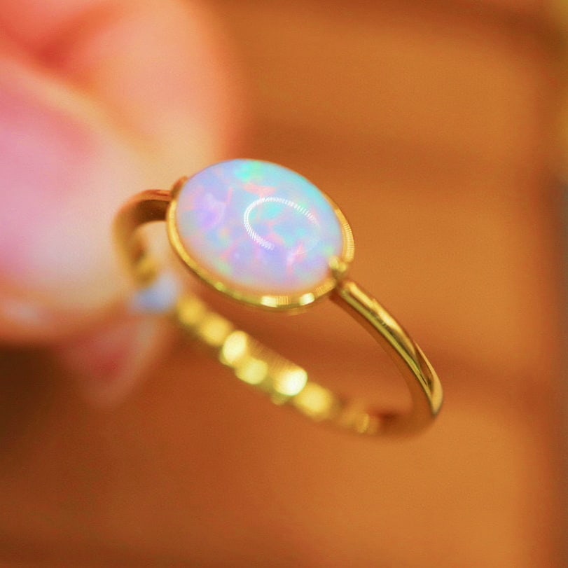 14k Gold 0.7 Ct Natural Opal Ring: Ref:231007161 // gold content:14k gold // ring size:7. 25us // // main gemstone:opal // shape:oval // carat weight:0. 7ct // color:white // treatment:natural // Low Estimate: 1300 High Estimate: 2000