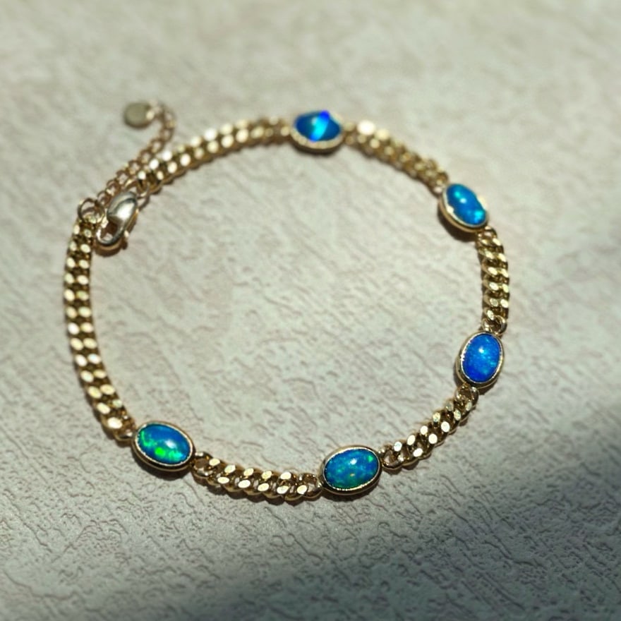 14k Gold 1.3 Ct Natural Opal Bracelet: Ref:231008102 // gold content:14k gold // main gemstone:opal // shape:oval // carat weight:1. 3ct // color:color // treatment:natural // Condition: New Low Estimate: 3700.00 High Estimate: 5600.00