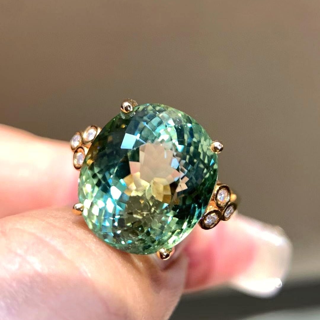 14k Gold 13 Ct Natural Tourmaline & Diamond Ring: Ref:231008286 // gold content:14k gold // ring size:7. 25us // // main gemstone:tourmaline // shape:oval // carat weight:13ct // color:green // treatment:natural // // adjacent gemstone 2 : diamond
