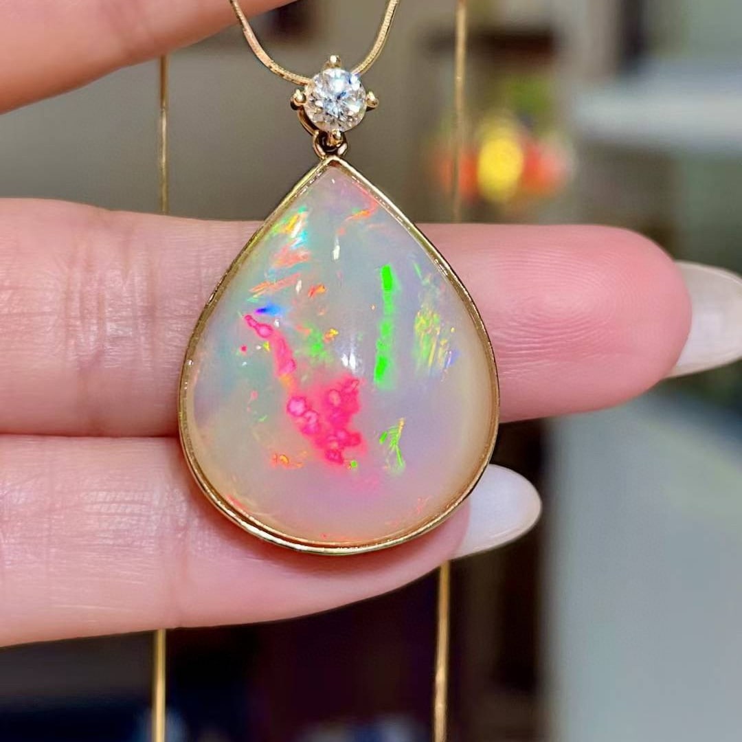 14k Gold 15.57 Ctw Natural Opal & Diamond Pendant( Without Chain ): Ref:231008313 // gold content:14k gold // main gemstone:opal // shape:pear // carat weight:15. 32ct // color:color // treatment:natural // // adjacent gemstone 2 : diamond // shape:round // carat weig