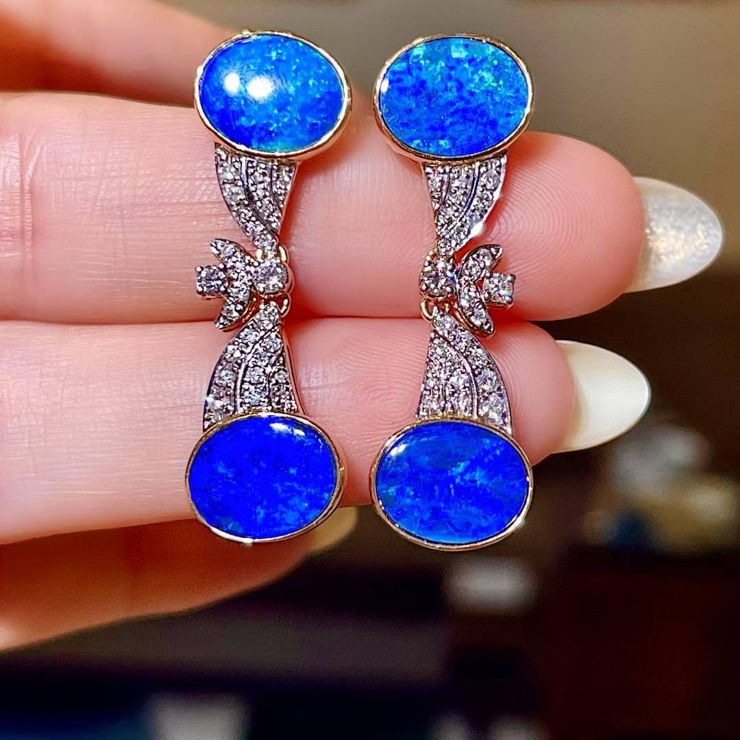 14k Gold 6.36 Ctw Natural Opal & Diamond Earrings: Ref:231008380 // gold content:14k gold // main gemstone:opal // shape:oval // carat weight:5. 9ct // color:blue // treatment:natural // // adjacent gemstone 2 : diamond // shape:round // carat weight: