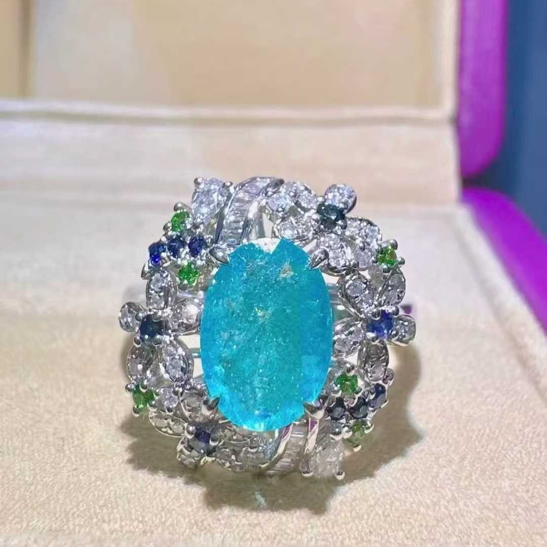 14k Gold 1.43 Ctw Natural Paraiba Tourmaline & Diamond Ring: Ref:231117189 // gold content:14k gold // ring size:7. 25us // // main gemstone:paraiba tourmaline // shape:oval // carat weight:1. 15ct // color:blue // treatment:natural // // adjacent gemstone 2 :
