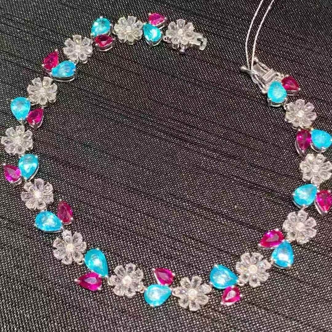 14k Gold 9.3 Ct Natural Paraiba Tourmaline & Ruby Bracelet: Ref:231117190 // gold content:14k gold // main gemstone:paraiba tourmaline & ruby // shape:pear // carat weight:9. 3ct // color:blue & red // treatment:natural // Condition: New Low Estimate: 21800 Hi
