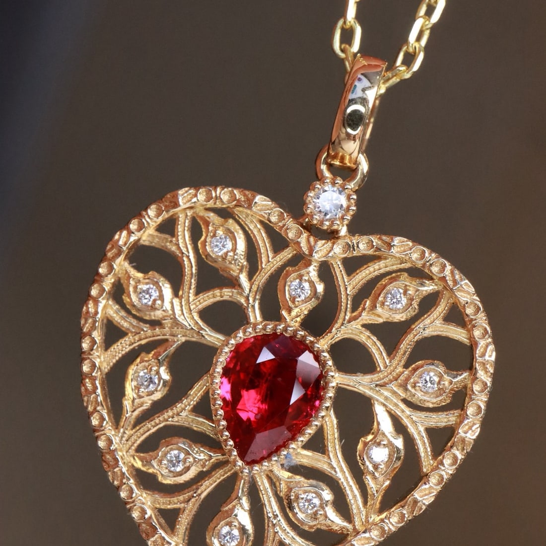 14k Gold 0.58 Ctw Natural Ruby & Diamond Pendant( Without Chain ): Ref:231118385 // gold content:14k gold // main gemstone:ruby // shape:pear // carat weight:0. 51ct // color:red // treatment:natural // // adjacent gemstone 2 : diamond // shape:round // carat